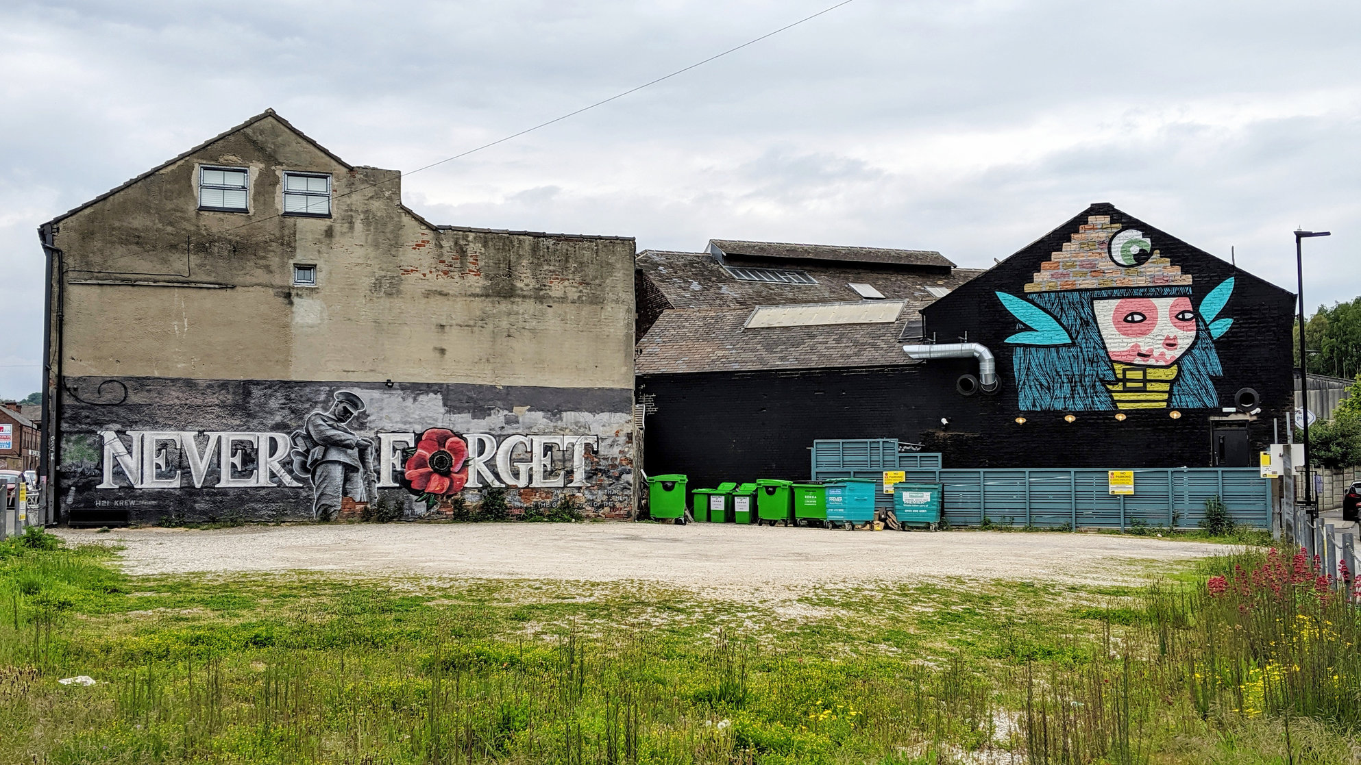 Two buildings in Neepsend, one with a mural remembering those lost to the World Wars, the other has artwork by Kid Acne