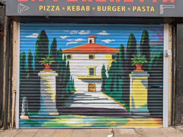 Mural of an Italian villa on some shop shutters